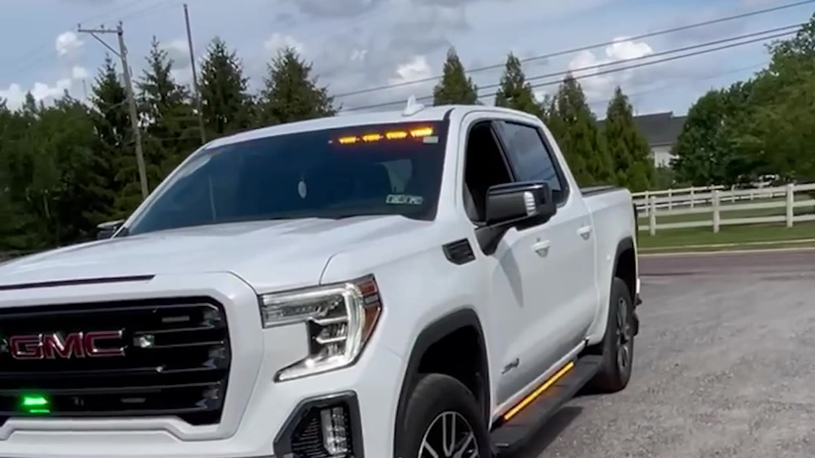 White GMC Sierra crew cab with a low-profile warning package