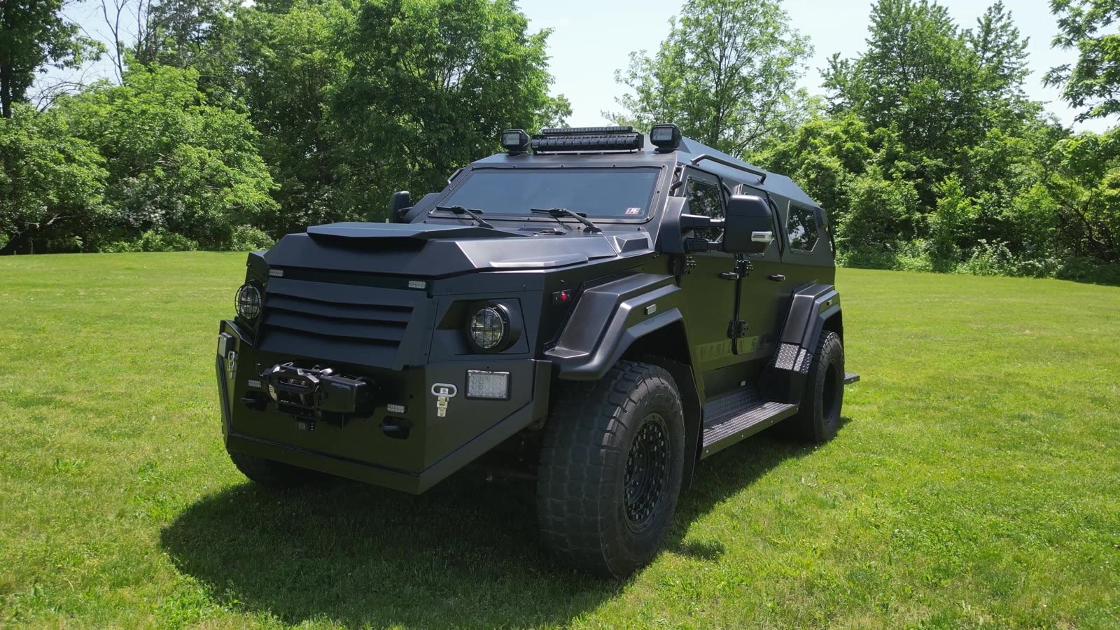 Front three-quarter showing the grille and spot lamps
