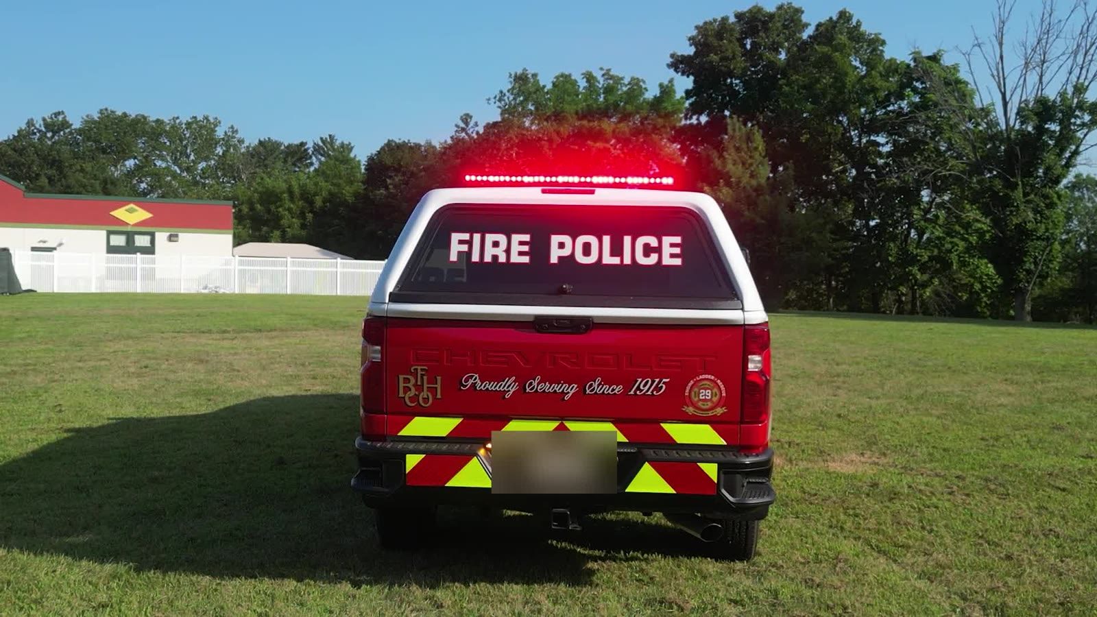 Rear view with the lighted FIRE POLICE sign and chevron